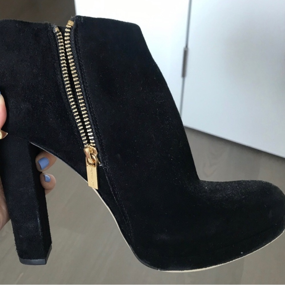 Black Michael Kors booties with gold accents